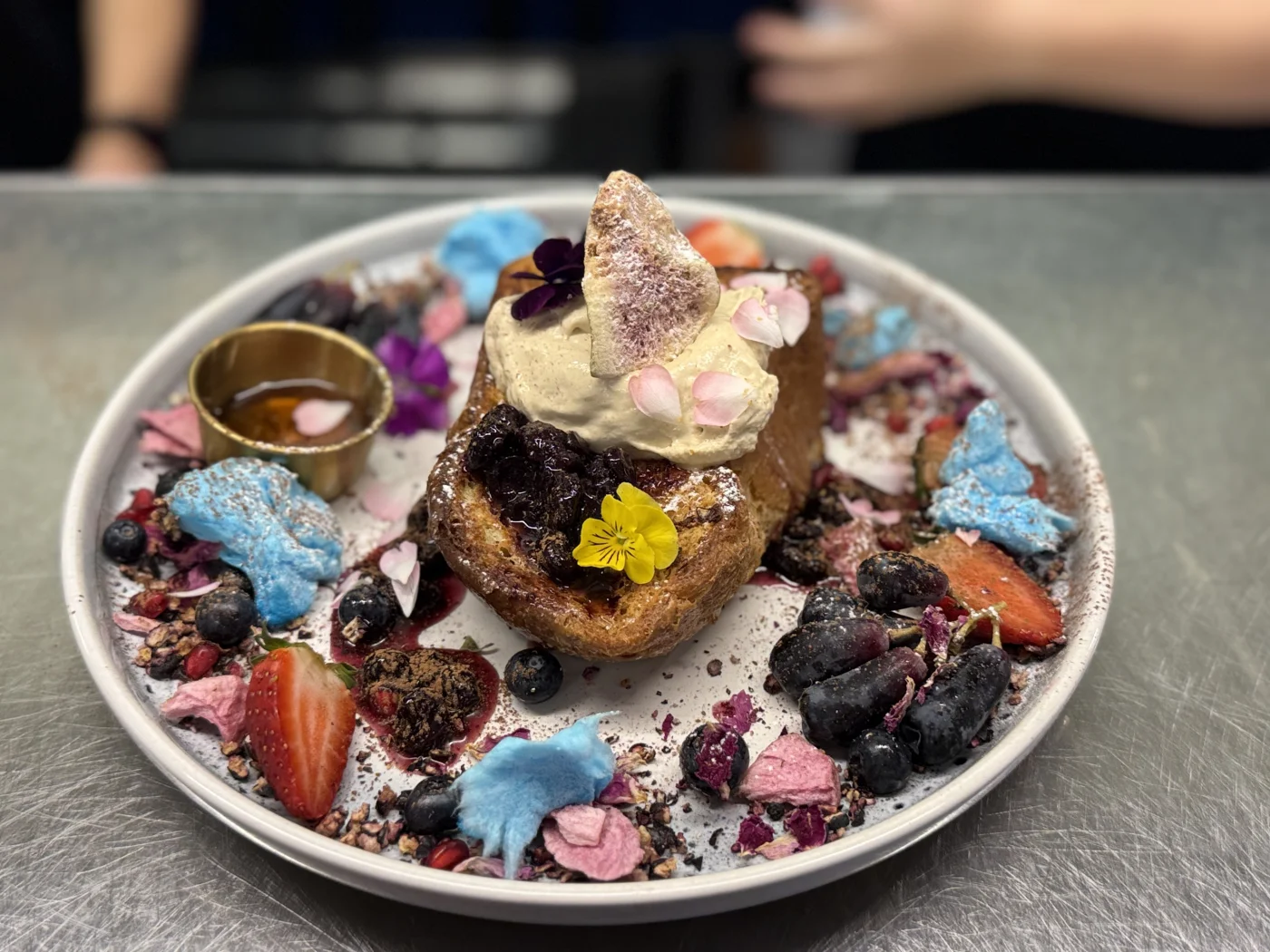 French toast with edible flowers and berries